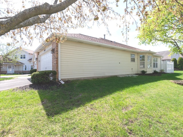 exterior space featuring a garage, a yard, and concrete driveway