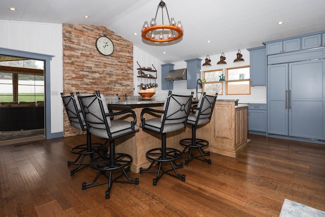 554 Fairway Dr, El Paso, IL 61738 - dining area featuring a chandelier, dark wood-style flooring, and lofted ceiling