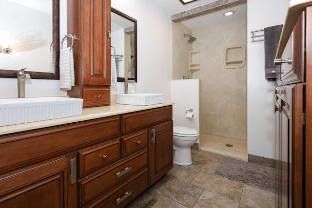 554 Fairway Dr, El Paso, IL 61738 - bathroom featuring double vanity, toilet, a walk in shower, and a sink