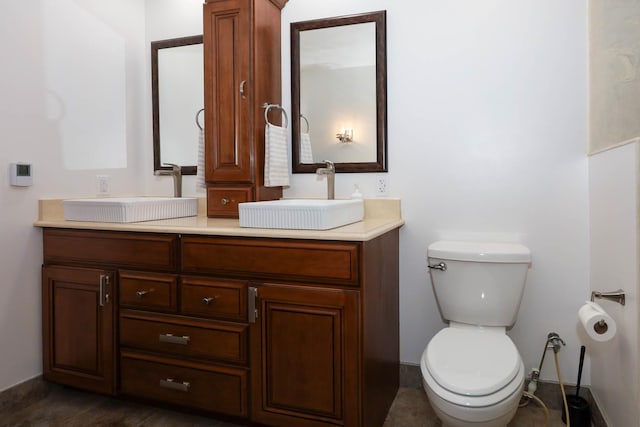 554 Fairway Dr, El Paso, IL 61738 - full bath with toilet, a sink, double vanity, and baseboards
