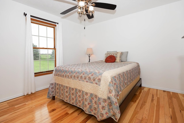 554 Fairway Dr, El Paso, IL 61738 - bedroom with hardwood / wood-style floors, baseboards, and ceiling fan
