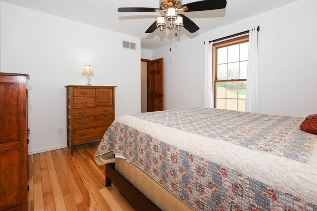 554 Fairway Dr, El Paso, IL 61738 - bedroom featuring ceiling fan, baseboards, visible vents, and light wood-style flooring