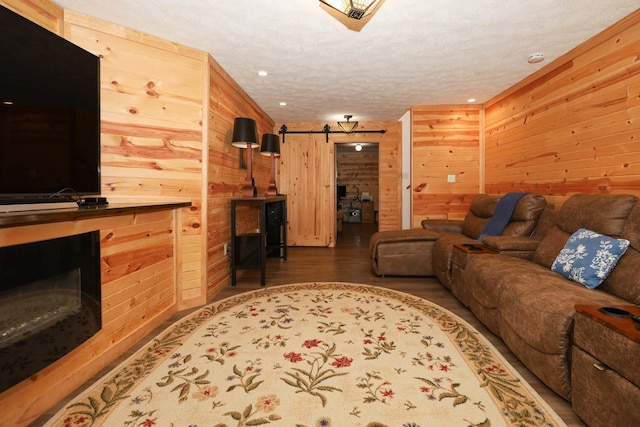 554 Fairway Dr, El Paso, IL 61738 - living area with a fireplace, wood finished floors, wooden walls, and recessed lighting