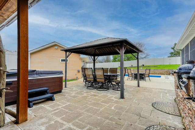 554 Fairway Dr, El Paso, IL 61738 - view of patio featuring outdoor dining area, a fenced backyard, a hot tub, a gazebo, and grilling area