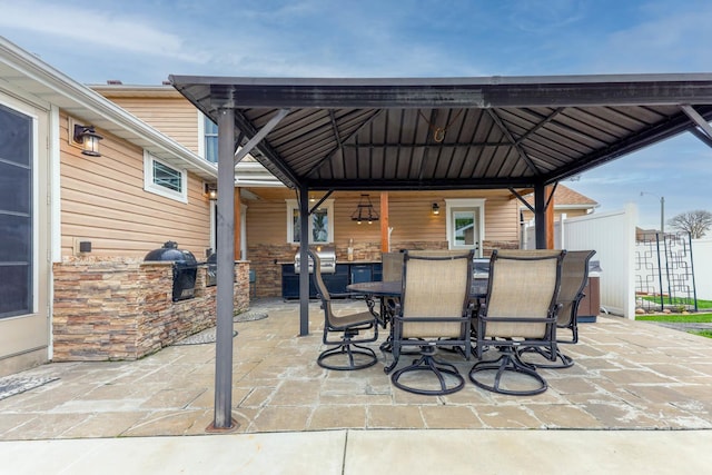 554 Fairway Dr, El Paso, IL 61738 - view of patio / terrace with outdoor dining area, exterior kitchen, area for grilling, a gazebo, and fence