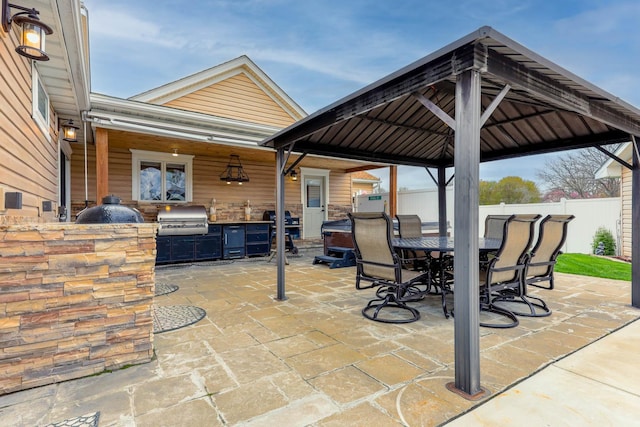 554 Fairway Dr, El Paso, IL 61738 - view of patio featuring grilling area, an outdoor kitchen, a gazebo, fence, and outdoor dining area