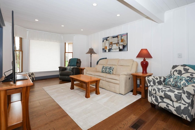 554 Fairway Dr, El Paso, IL 61738 - living area featuring beam ceiling, wood finished floors, a decorative wall, and visible vents