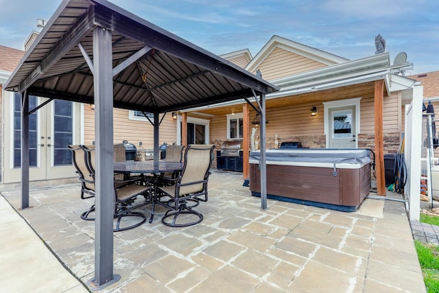 554 Fairway Dr, El Paso, IL 61738 - view of patio / terrace with outdoor dining area, a gazebo, a hot tub, and french doors
