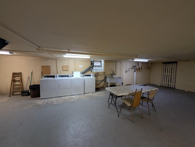 below grade area featuring separate washer and dryer and a sink