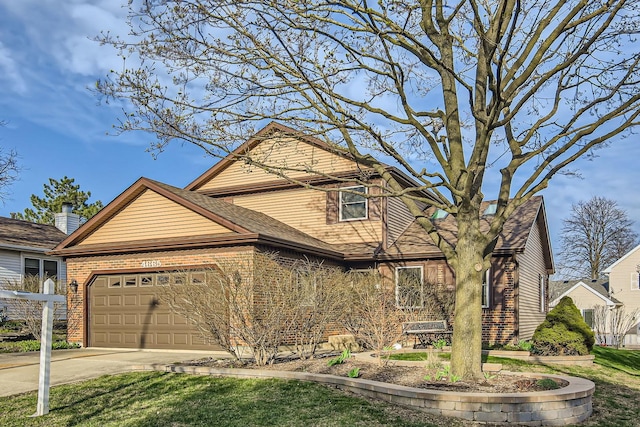 traditional home with an attached garage, driveway, and brick siding