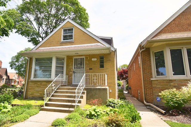 5759 N Moody Ave, Chicago, IL 60646 - view of front facade featuring a porch and stone siding