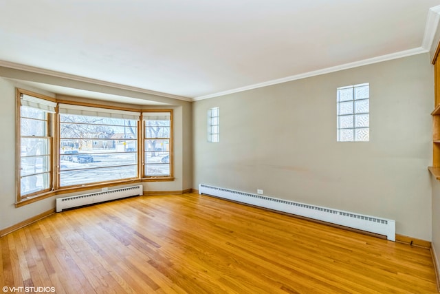 unfurnished room with a baseboard heating unit, light wood-style flooring, baseboards, baseboard heating, and crown molding