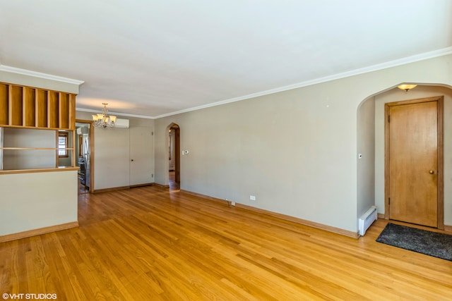 unfurnished living room featuring a baseboard heating unit, arched walkways, light wood-style floors, a chandelier, and ornamental molding