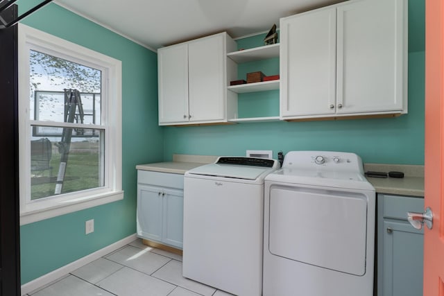 1926 County Road 2800 E, Minonk, IL 61760 - laundry area featuring washing machine and clothes dryer, baseboards, light tile patterned floors, and cabinet space