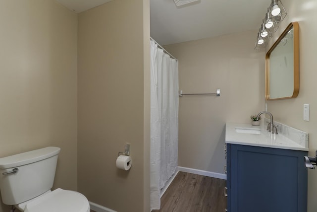 1926 County Road 2800 E, Minonk, IL 61760 - bathroom featuring baseboards, wood finished floors, vanity, and toilet