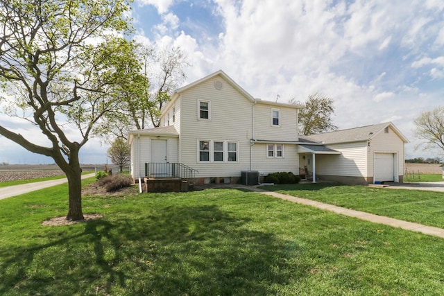 1926 County Road 2800 E, Minonk, IL 61760 - traditional-style home with central air condition unit, an attached garage, driveway, and a front yard