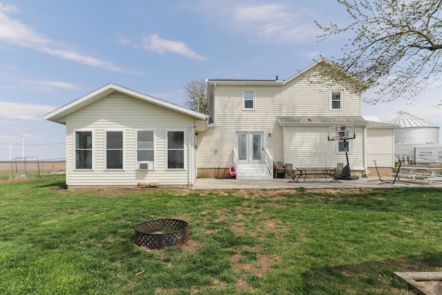 1926 County Road 2800 E, Minonk, IL 61760 - rear view of house featuring entry steps, a patio area, an outdoor fire pit, and a lawn
