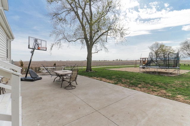 1926 County Road 2800 E, Minonk, IL 61760 - view of patio featuring a rural view, a trampoline, and outdoor dining space