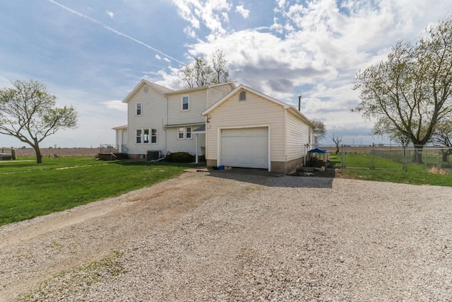 1926 County Road 2800 E, Minonk, IL 61760 - view of front of property with gravel driveway, central AC unit, fence, an attached garage, and a front yard