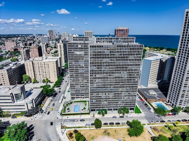 birds eye view of property featuring a view of city and a water view