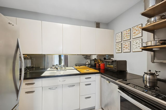 kitchen featuring visible vents, open shelves, a sink, stainless steel appliances, and white cabinetry