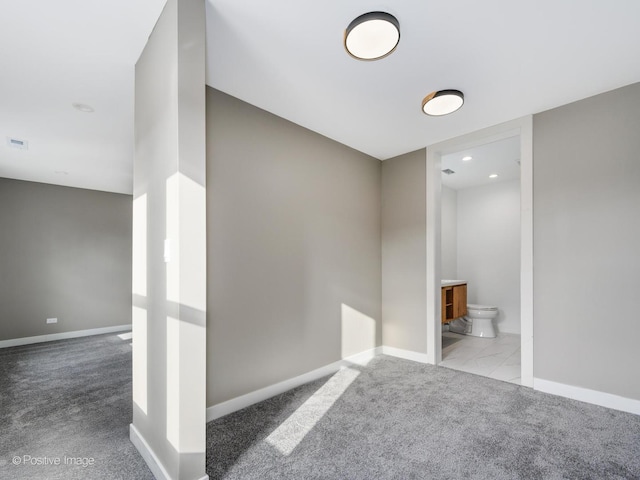 interior space featuring visible vents, baseboards, and carpet flooring