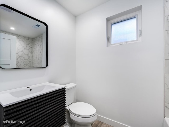 bathroom with visible vents, wood finished floors, vanity, and toilet