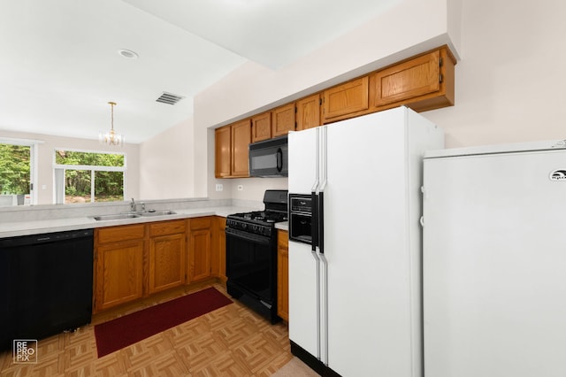 8235 Ripple Rdg, Darien, IL 60561 - kitchen with black appliances, a sink, light countertops, a chandelier, and brown cabinets