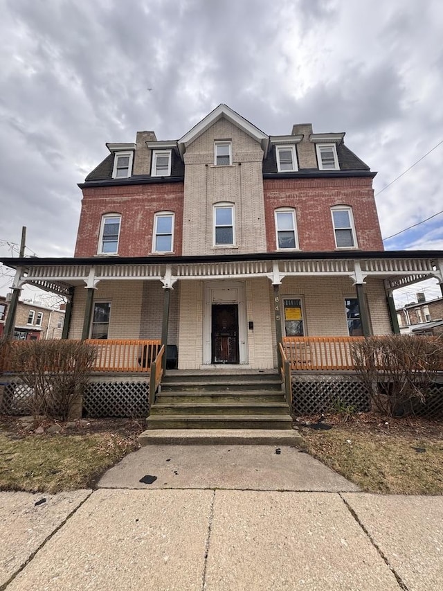 645 E 113th St, Chicago, IL 60628 - victorian home with a porch, brick siding, and mansard roof