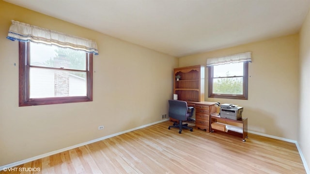 office area featuring baseboards, light wood-style floors, and visible vents
