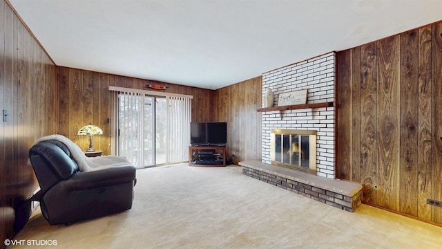 carpeted living room featuring wooden walls and a brick fireplace