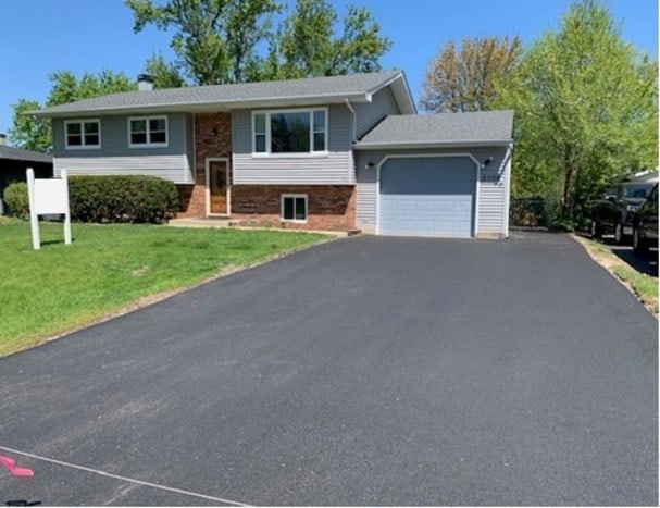 5108 N W St, Mchenry, IL 60051 - bi-level home featuring a garage, driveway, and a front lawn
