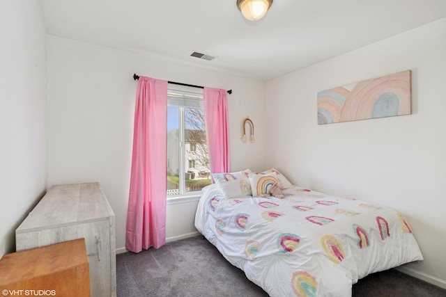 carpeted bedroom with visible vents and baseboards