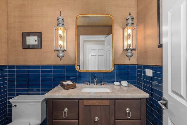 20 Colony Ln, Deerfield, IL 60015 - half bathroom featuring tile walls, vanity, toilet, and a wainscoted wall