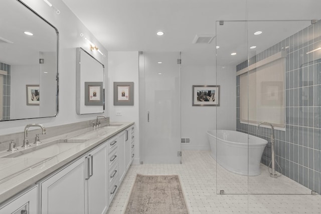 20 Colony Ln, Deerfield, IL 60015 - bathroom featuring a freestanding tub, double vanity, recessed lighting, tile patterned flooring, and tile walls