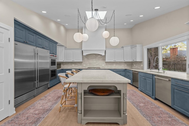 20 Colony Ln, Deerfield, IL 60015 - kitchen featuring stainless steel appliances, blue cabinets, open shelves, a sink, and decorative backsplash