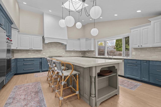 20 Colony Ln, Deerfield, IL 60015 - kitchen with blue cabinetry, a sink, white cabinetry, high vaulted ceiling, and recessed lighting