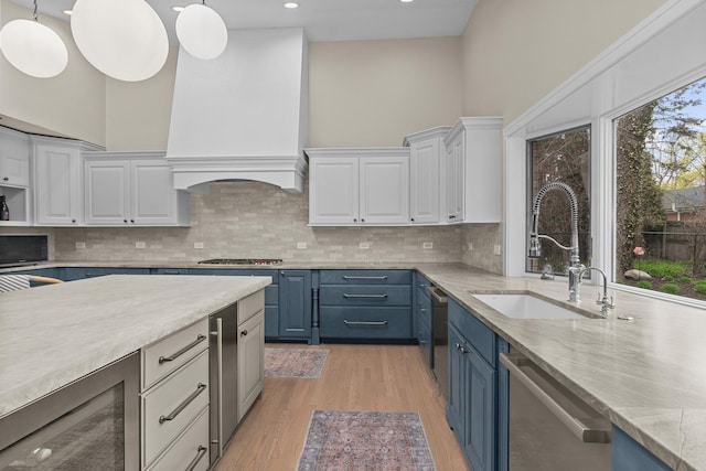 20 Colony Ln, Deerfield, IL 60015 - kitchen featuring blue cabinets, a sink, custom range hood, stainless steel appliances, and recessed lighting
