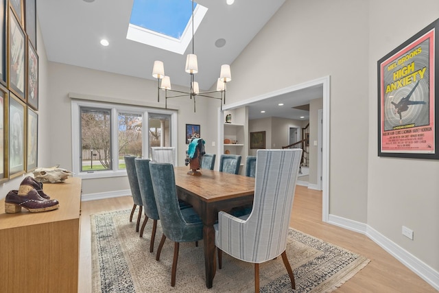 20 Colony Ln, Deerfield, IL 60015 - dining area with high vaulted ceiling, light wood-style floors, a skylight, a chandelier, and baseboards