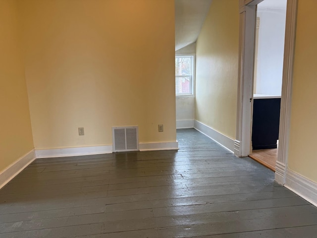 310 Elk St, Galena, IL 61036 - unfurnished room with baseboards, vaulted ceiling, visible vents, and dark wood-type flooring