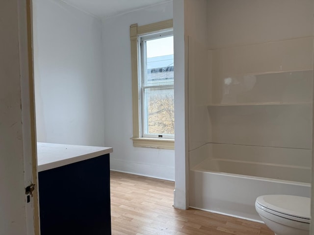 310 Elk St, Galena, IL 61036 - bathroom with baseboards, wood finished floors, vanity, and toilet