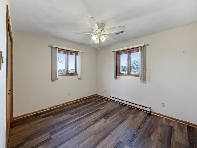 empty room featuring a ceiling fan, visible vents, a baseboard radiator, and a healthy amount of sunlight