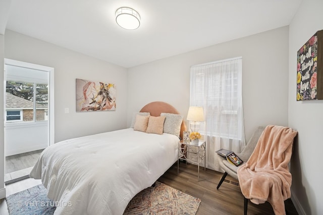 bedroom with baseboards and wood finished floors