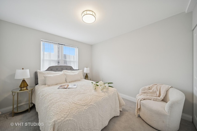 carpeted bedroom featuring baseboards