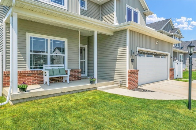 715 Cole Ln, Mahomet, IL 61853 - entrance to property with a porch, brick siding, concrete driveway, and a lawn