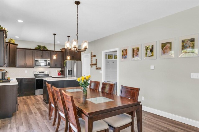 715 Cole Ln, Mahomet, IL 61853 - dining space featuring light wood-style floors, a chandelier, and recessed lighting