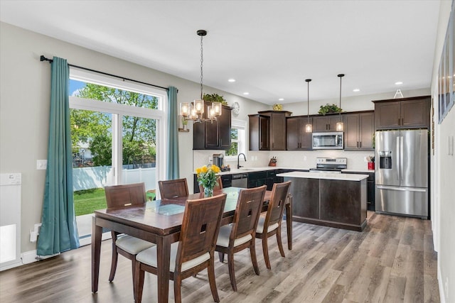 715 Cole Ln, Mahomet, IL 61853 - dining area featuring light wood finished floors, a chandelier, and recessed lighting