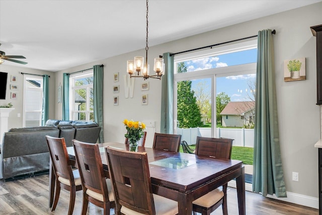 715 Cole Ln, Mahomet, IL 61853 - dining room featuring light wood-type flooring, baseboards, and ceiling fan with notable chandelier