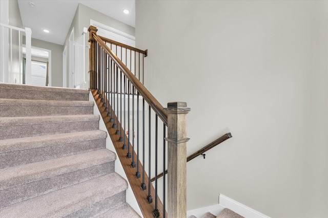 staircase featuring carpet flooring, recessed lighting, and baseboards