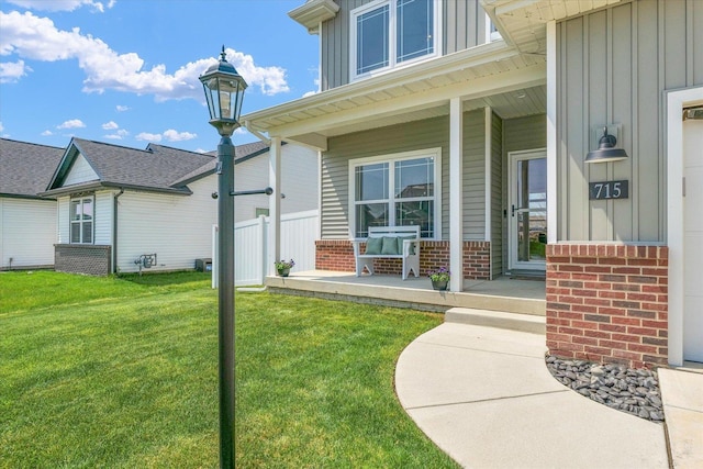 715 Cole Ln, Mahomet, IL 61853 - view of exterior entry featuring board and batten siding, a porch, and brick siding